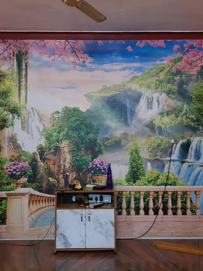 This full-wall mural creates a stunning illusion of a balcony overlooking a fantasy waterfall landscape. It dramatically opens up the room and adds a sense of depth and wonder.