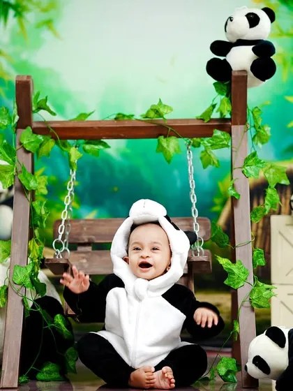 A happy little panda, laughing and playing in our bamboo forest-themed studio.