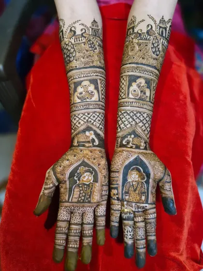 This angle highlights the symmetry and balance in the full-arm bridal portrait mehendi, with each arm telling a part of the wedding story.
