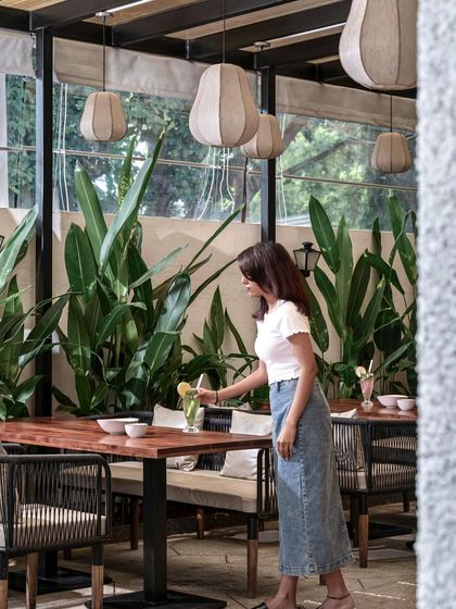 Seeing guests enjoy the spaces I create is the ultimate reward. The combination of natural light, greenery, and comfortable seating makes this outdoor area a perfect spot for a relaxed meal.