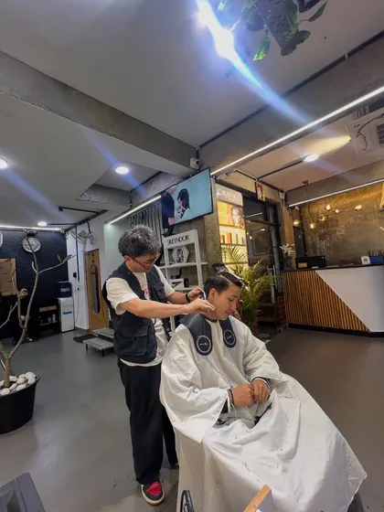 Our lead stylist, Yewong, at work, giving a client a precision haircut.