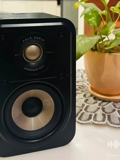 The Polk Audio Signature Elite ES10 compact surround speaker, shown here with its grille off. You can see the high-resolution Terylene dome tweeter and the mica-fortified polypropylene woofer that deliver cinematic sound.