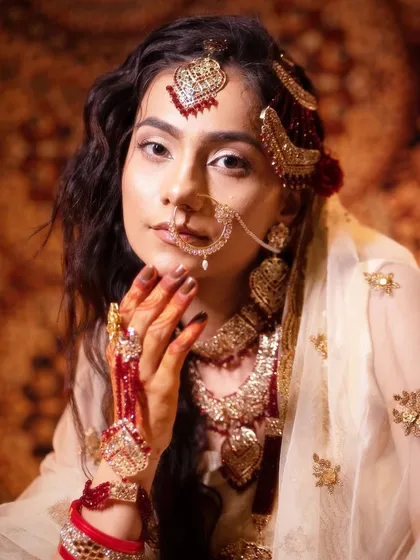 A close-up of a student's work on a traditional look, highlighting the intricate details of the eye makeup, jewelry, and hair accessories. I teach you to perfect every single element.