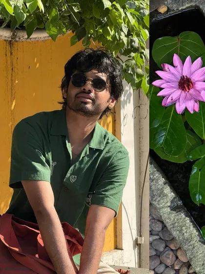 A quiet moment of contemplation against a yellow wall in Pondicherry.