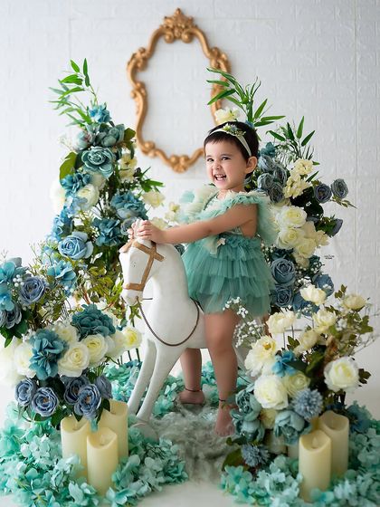 A joyful ride on the rocking horse through a garden of blue and white flowers.