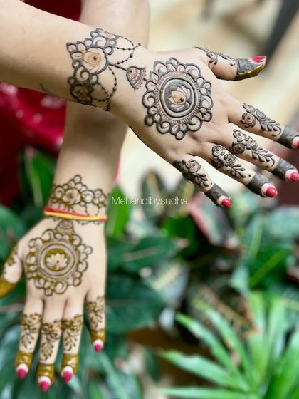 A minimalist design for Gangaur, featuring a simple lotus mandala on the back of the hand with delicate finger details. It's an elegant choice for any festival.