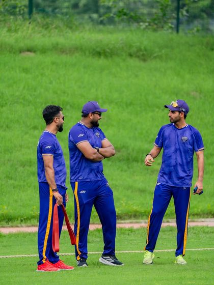 A candid conversation on the field. Building a strong rapport with players and fellow coaches is essential for a cohesive and successful team environment.