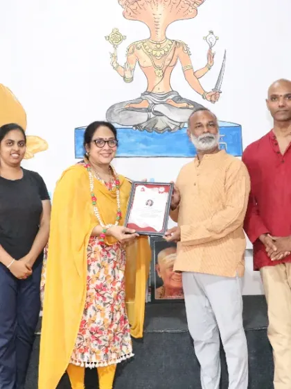 A student is awarded her certificate for the 200-hour Ashtanga and Hatha Yoga TTC.