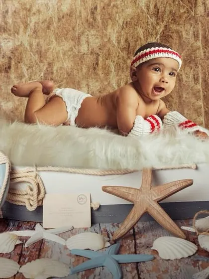 For this six-month milestone shoot, we went with a fun nautical theme. My studio is equipped with a wide range of props like these to bring any creative vision for your baby's photoshoot to life.