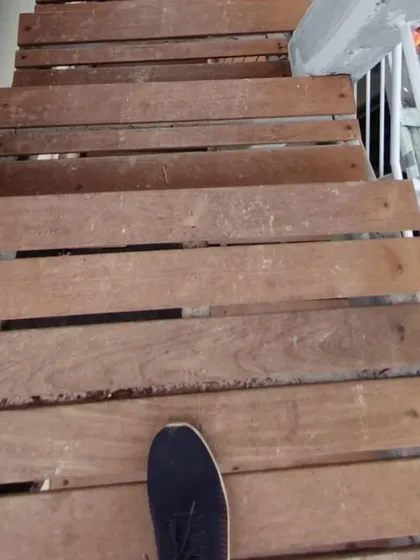 A first-person view walking down the custom-built wooden steps, demonstrating their practical application.