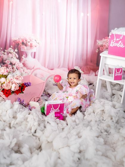 A quiet moment in a pink paradise. This little girl enjoys a balloon in her Barbie-themed wonderland, creating a sweet and candid portrait.