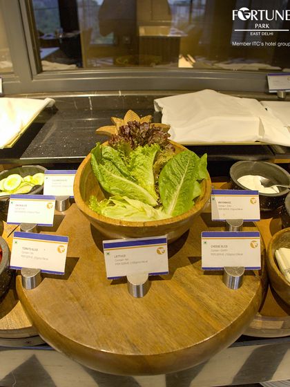 The fresh salad bar at our buffet, with crisp lettuce, cucumbers, and tomatoes ready for you to create your own salad.