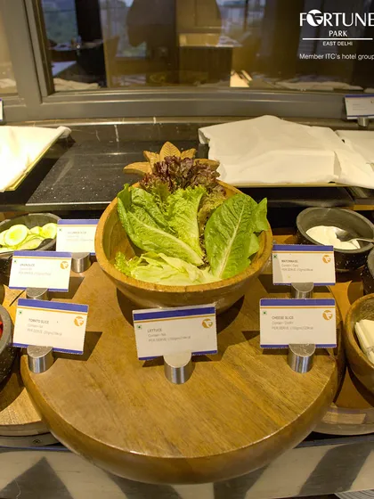 The fresh salad bar at our buffet, with crisp lettuce, cucumbers, and tomatoes ready for you to create your own salad.