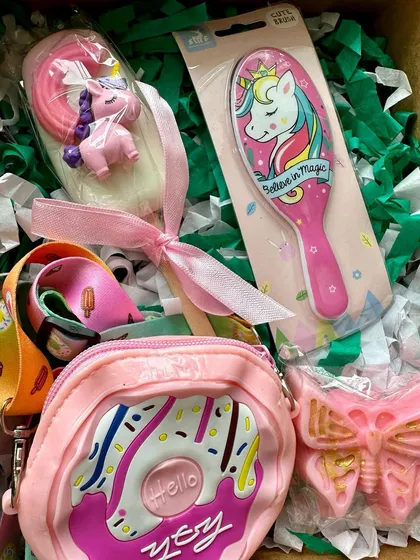 A delightful unicorn-themed gift box for girls, featuring soaps, a donut sling bag, and a hairbrush.