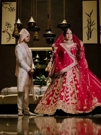 A classic portrait from Ritish and Aastha's wedding day in Delhi. I aim for timeless elegance in my couple portraits, creating images that feel both grand and personal. The bride's stunning red lehenga and the groom's coordinated sherwani made for a truly regal shot.