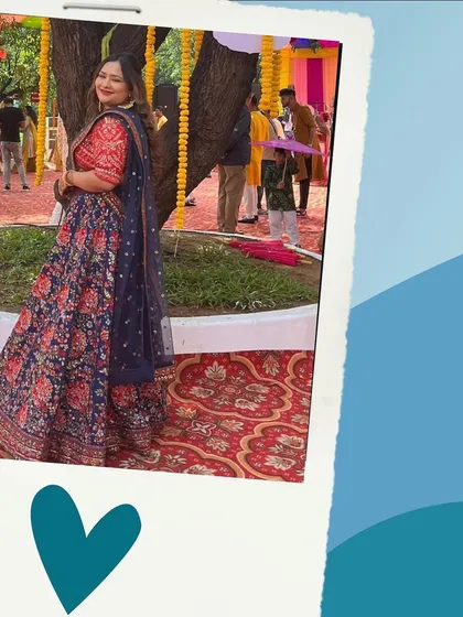 A happy client enjoying an outdoor function in a beautiful navy and red floral lehenga. My outfits are designed for every kind of celebration.
