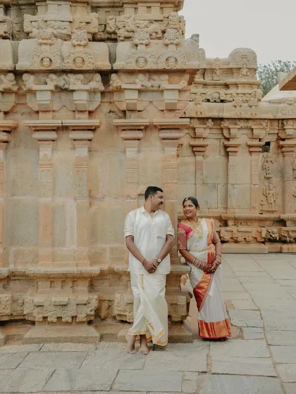 A happy, relaxed portrait of the couple standing in front of a beautifully carved temple wall. Their comfortable smiles show the easy-going and enjoyable atmosphere I create during my shoots.