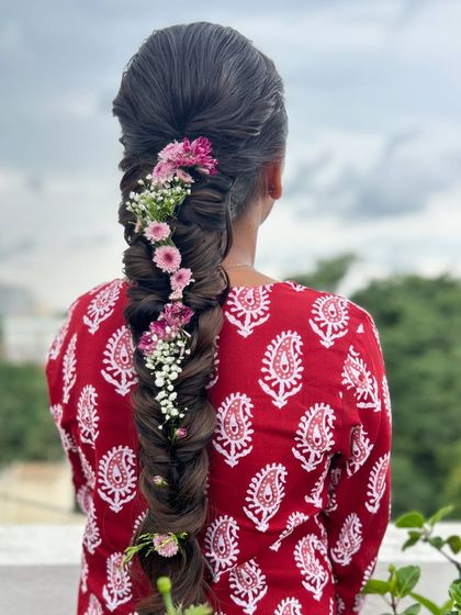 A beautiful shot of the floral fishtail braid against a natural background, perfect for a daytime event.