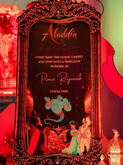 The official welcome sign for the party, designed in the Aladdin theme and framed in an ornate, vintage-style mirror.
