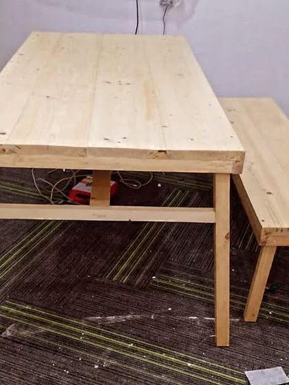 This simple yet sturdy pine wood table and bench set was created for an office breakout area. It provides a casual and collaborative space for employees to relax or have informal meetings.