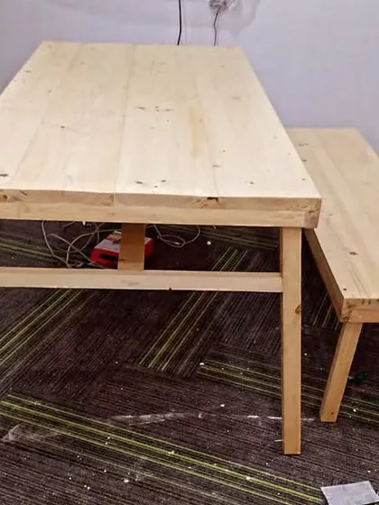 This simple yet sturdy pine wood table and bench set was created for an office breakout area. It provides a casual and collaborative space for employees to relax or have informal meetings.