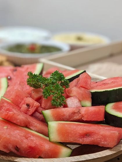 A refreshing platter of freshly sliced watermelon, perfect for a summer event. A simple, healthy, and hydrating option that everyone enjoys.