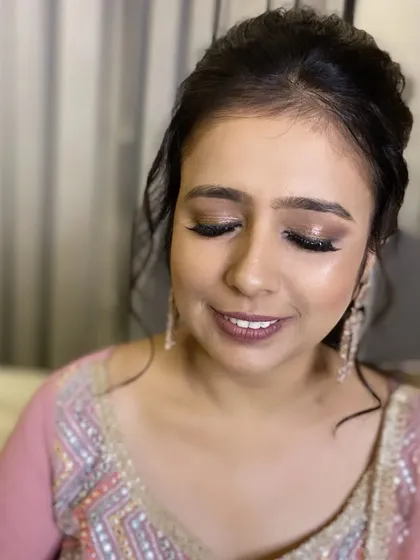 My stunning bride is all set for her Cocktail Party. I created a glamorous look with shimmery, smokey eyes and a soft pink lip.