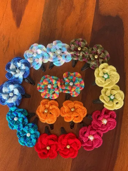 A beautiful array of my handmade floral hair clips. Available in a wide variety of colors, from vibrant multi-color to rich single tones, each with a delicate pearl center.