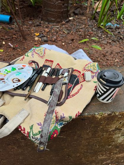 My typical setup for a day of outdoor sketching. Just my art kit, a coffee, and a good view.