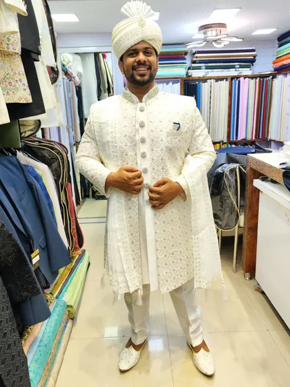 A happy groom is the best testament to my work. Here is a client looking radiant in a custom all-white, embroidered sherwani, complete with a matching safa (turban) and juttis for his special day.