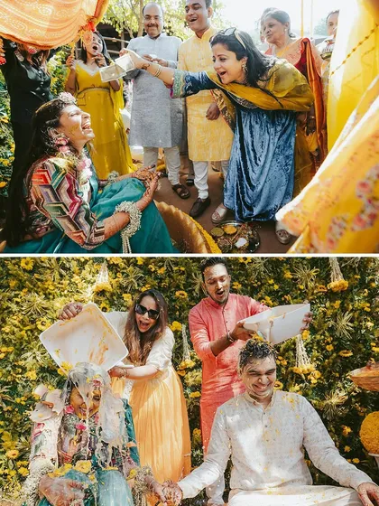 More moments from a fun-filled Haldi. We love capturing the playful interactions, like friends pouring buckets of flowers and turmeric on the happy couple.