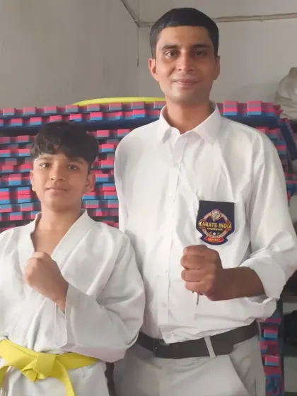 With one of my yellow-belt students. Every belt level is a milestone on the path to becoming a champion.