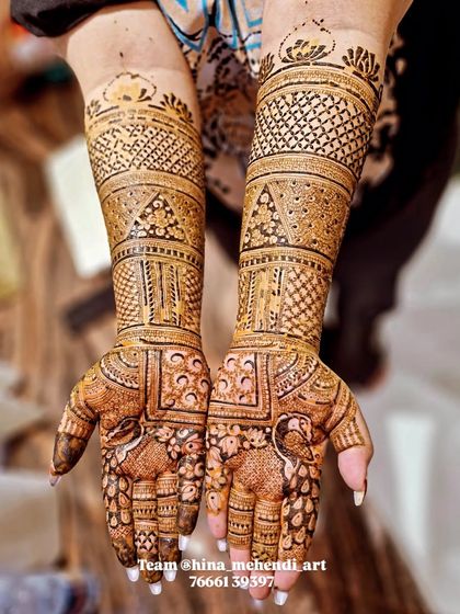 A beautiful design featuring peacocks on the palms, with the arms covered in traditional bands of patterns. Done by my talented team.