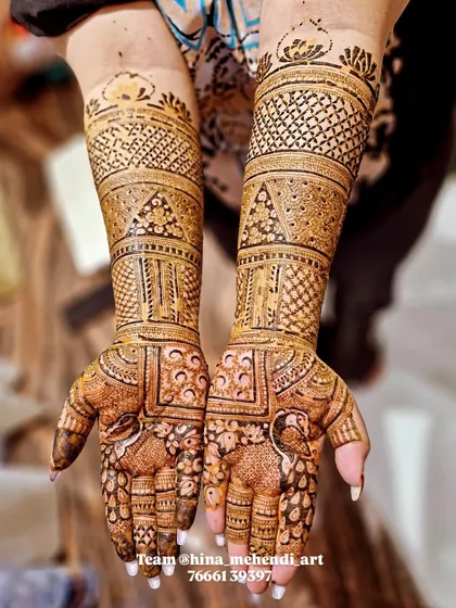 A beautiful design featuring peacocks on the palms, with the arms covered in traditional bands of patterns. Done by my talented team.