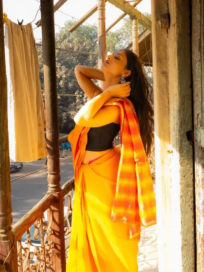Using the natural light on a balcony overlooking a Delhi street. The pose is relaxed and captures the feeling of soaking in the sun.