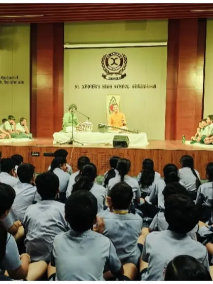 Another perspective of the performance at St. Xavier's, showing the full audience of students.