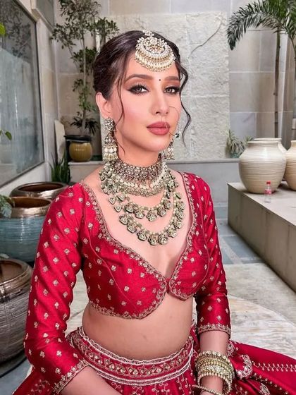 A beautiful portrait of the bride, with a focus on her serene expression and the stunning bridal jewelry.