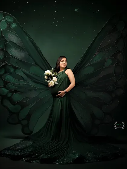 A truly unique and artistic portrait, with giant green butterfly wings transforming the mother-to-be into a mythical, beautiful creature.