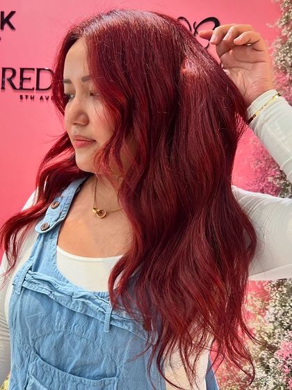 A vibrant red created with Redken color. This shade is bold, confident, and guaranteed to turn heads.