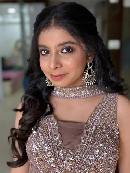 A full-face view, showing her confidence and the polished finish of the makeup.