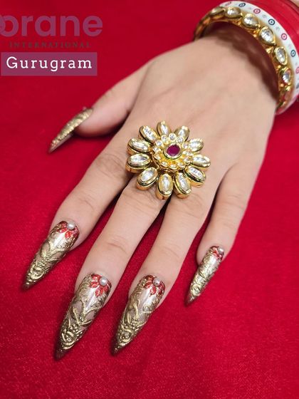 Another angle of the intricate Karwa Chauth nails, showing the detailed patterns and stiletto shape.