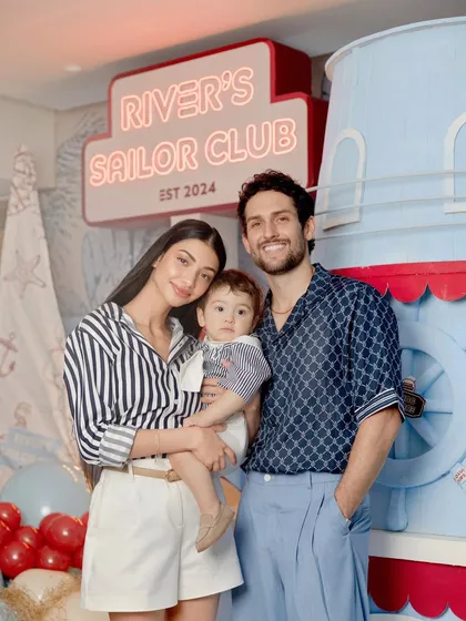 The happy family poses in front of the custom-built sailor club decor.