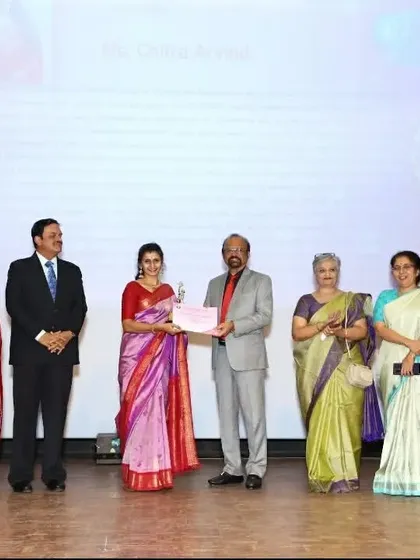 Receiving the award certificate on stage. My work extends beyond dance to include philanthropic projects, and this award acknowledges that social commitment.
