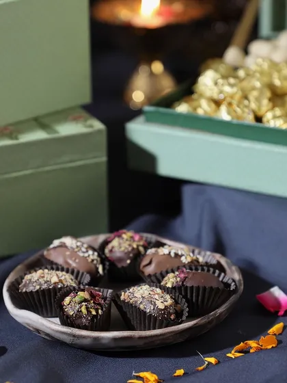 A tempting plate of our luxury assorted chocolates, a key component of many of our Diwali hampers. Each one is a small bite of indulgence.