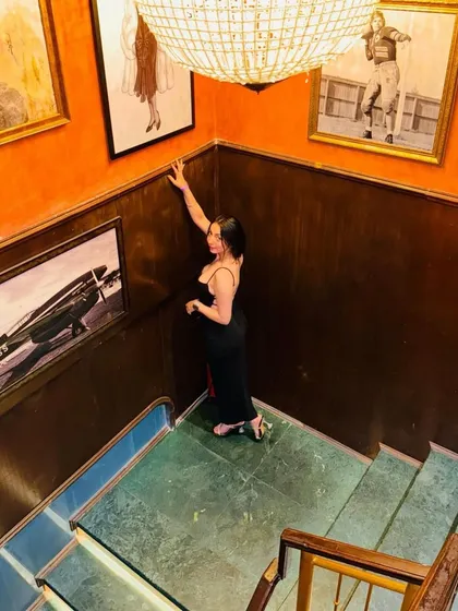 A wider angle of the staircase shot, giving more context to the unique, art-filled environment.
