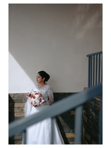A variation of the previous shot, framed through a railing. This composition adds depth and a sense of looking in on a private, beautiful moment.
