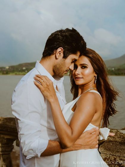 A beautiful close-up portrait where the woman connects with the camera while being held by her partner. This style of shot is both intimate and engaging.