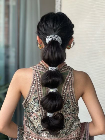 A back view of the stylish bubble ponytail, a modern and chic choice for any pre-wedding event.