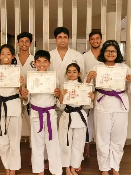 Students with new purple and black belts at our Virar branch, showcasing the path of progression from intermediate to advanced levels.