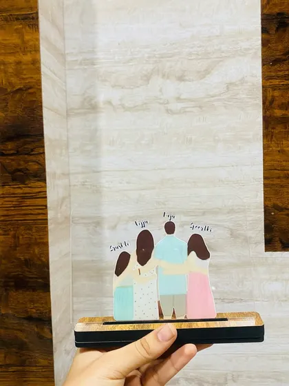 The family acrylic standee displayed against a textured wall. This shows how it can fit into different home environments, adding a personal and modern touch to your decor.